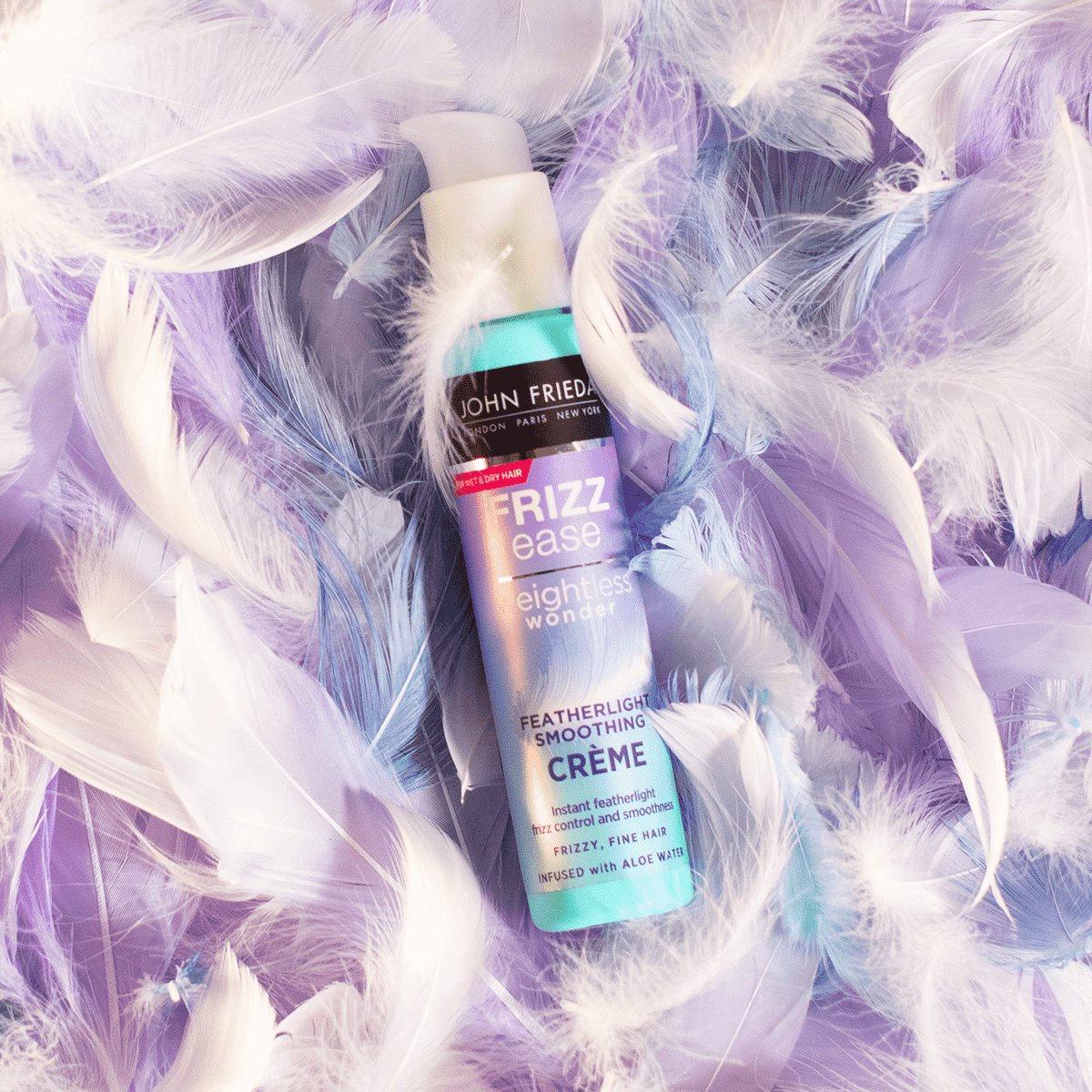 John Frieda product surrounded by feathers